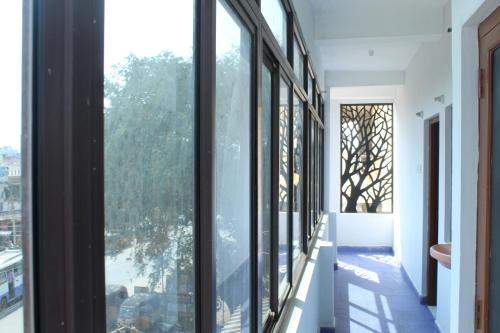 a hallway with windows and a view of a city at Fort Square Apartments - 201 in Vellore