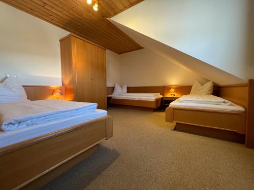 a room with two beds and a staircase at Hoamat House I Boutique Apartments in Sankt Margarethen im Lungau