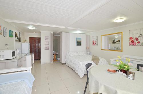 a hotel room with a bed and a kitchen and a room at Arum Field Accommodation in Table View