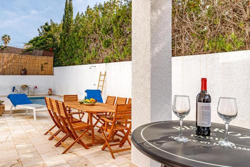 a bottle of wine sitting on a table on a patio at Albir Casa Marleen in Albir