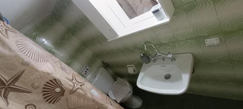 a small bathroom with a toilet and a sink at Floral Tribute Studio in Kavála