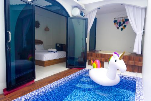 a room with a unicorn toy in a bedroom at M Bali 2 in Ngaglik