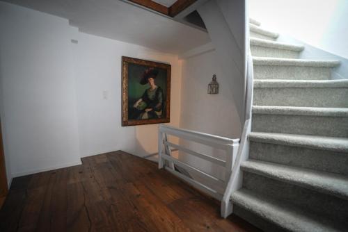 a staircase in a home with a painting on the wall at Rooftop Chalet 2-Level Apartment in Old Town in Zürich