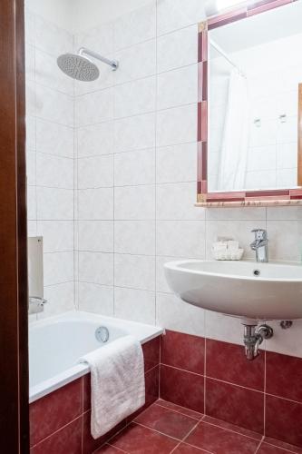 a bathroom with a sink and a bath tub at Antica Locanda Sturion Residenza d'Epoca in Venice
