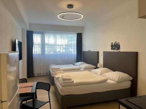Postel nebo postele na pokoji v ubytování Post 120 Suites