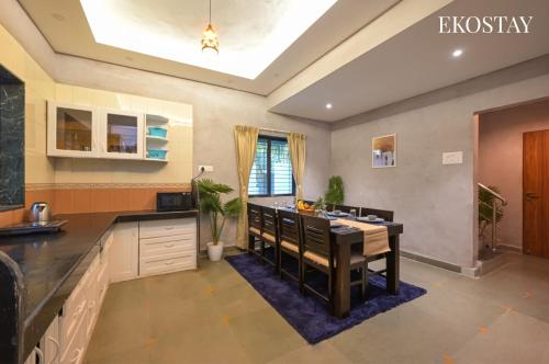 a kitchen with a island in the middle of it at EKOSTAY - Noir Villa in Alibaug