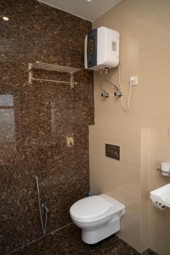 a bathroom with a toilet and a shower and a sink at Just Move Premium 2BR Suite, Near ISB Int'l AIRPT in Islamabad