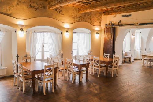 a dining room with wooden tables and chairs at Penzion Tlustá kachna in Chrudim
