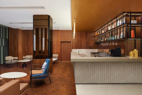 a kitchen with a counter and some tables and chairs at Fairfield by Marriott Amritsar in Amritsar