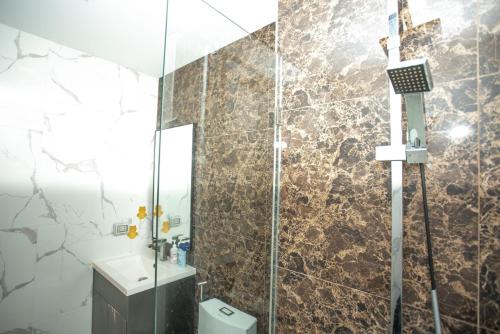 a bathroom with a shower with a toilet and a sink at Arcadia阿卡迪亚二期 in Pattaya South