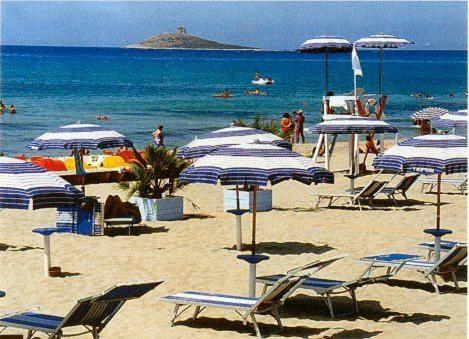 a beach with blue and white chairs and umbrellas at Paradiso del mare, Appartamento accogliente vicino a mare, metro, aeroporto e Palermo in Capaci
