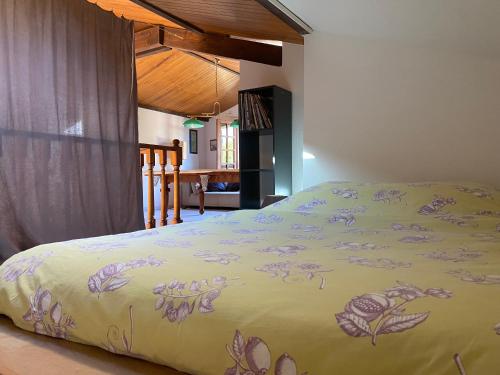 - un lit avec une couverture jaune et des fleurs violettes dans l'établissement Villa La Cantina, piscine, à Lège-Cap-Ferret