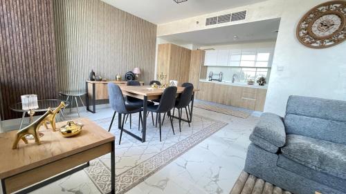 a living room with a blue couch and a table at Luxury Canal View Apartment Near Yas Island DABAS1 in Abu Dhabi