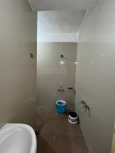 a bathroom with a toilet and a sink and a bucket at Amrapali Resort in Top