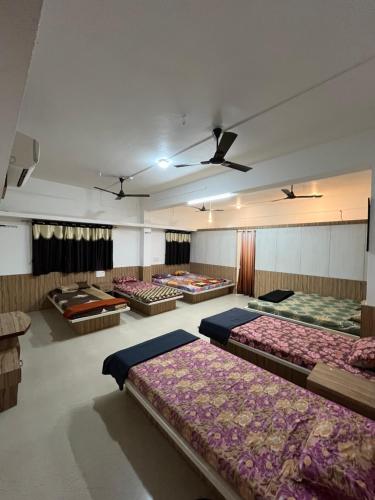 a room with a bunch of beds in it at Amrapali Resort in Top