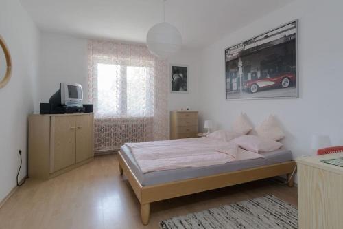 a bedroom with a bed and a tv in it at Villa Bella Vi in Hohentengen