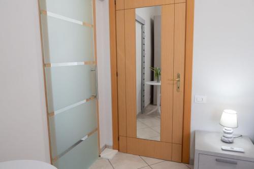 a bathroom with a glass door and a mirror at B&B Sibi in Chieti