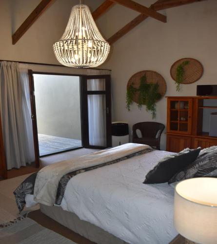 a bedroom with a large bed and a large window at 22 on Main Guesthouse Walvis Bay in Walvis Bay