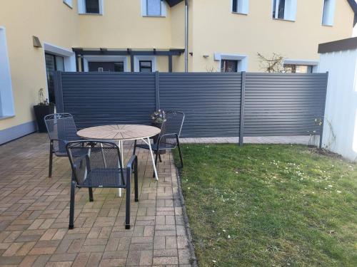 a patio with a table and chairs and a fence at Haus Wehlen in Stadt Wehlen