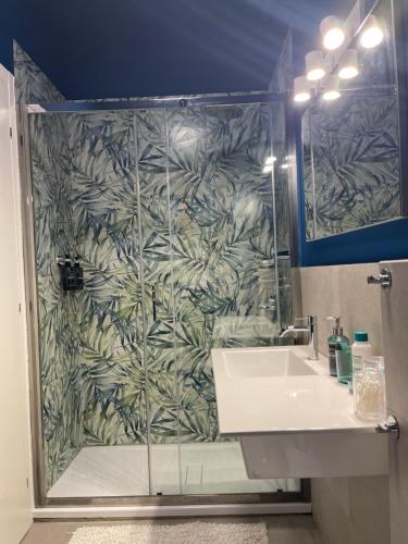 a bathroom with a shower with a sink and a mirror at B&B IL QUADRIFOGLIO in Iesi