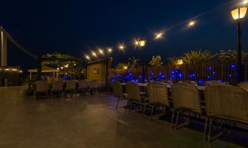 a dining area with tables and chairs at night at Treebo Eden Park, Ahmedabad in Ahmedabad