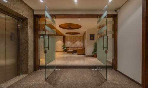 a hallway with a glass door leading into a lobby at Treebo Eden Park, Ahmedabad in Ahmedabad
