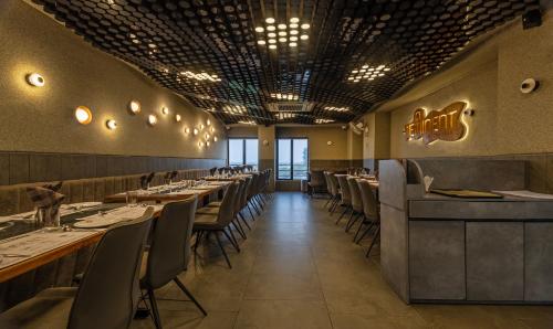 a dining room with long tables and chairs at Treebo Eden Park, Ahmedabad in Ahmedabad