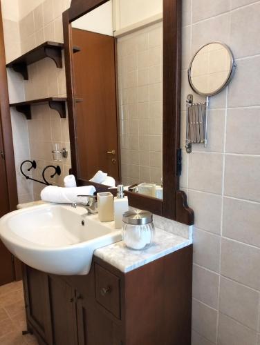 a bathroom with a sink and a mirror at La Casa del Lago in Porlezza