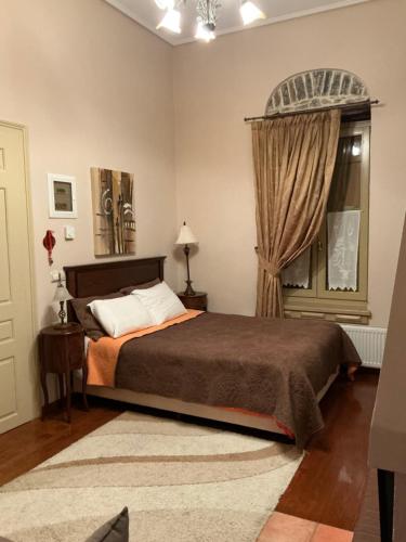 a bedroom with a bed and a window at Αρχοντικό Πρεπάλα in Neochori