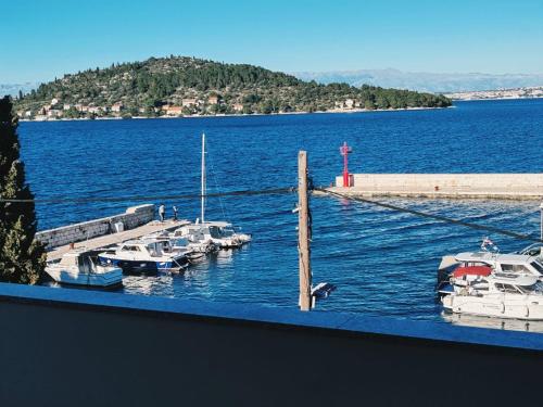 a group of boats docked at a dock in the water at Azure Apartment in Kali