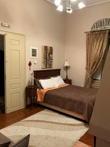 a bedroom with a bed and a window at Αρχοντικό Πρεπάλα in Neochori