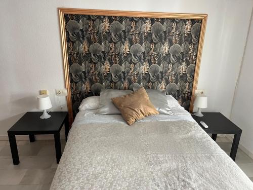 a bedroom with a bed with two side tables at PUERTO I Playa in Fuengirola