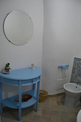 a bathroom with a blue table and a toilet at Maridea - Cave Apartments in Ponza