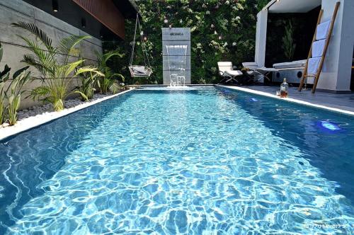 a swimming pool with blue water in a backyard at סוויטות בל - סוויטות יוקרה עם בריכה פרטית in Safed