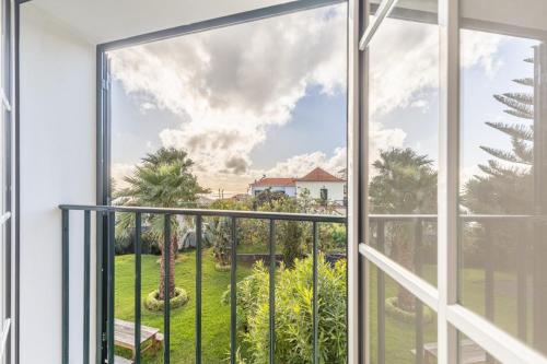 an open window with a view of a yard at Quinta Alegre in Calheta