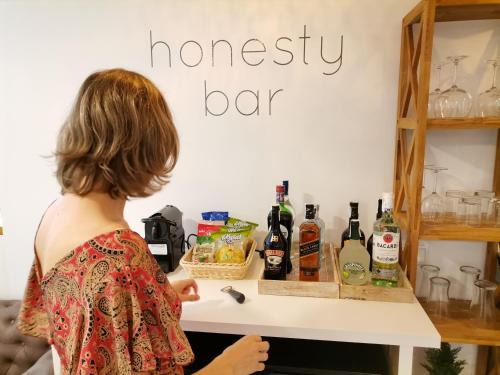 a woman standing in front of a bar with bottles of wine at Hotel hcp in Calella de Palafrugell