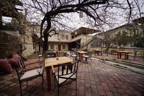 a group of tables and chairs in a courtyard at Glory Art Stone House in Goreme