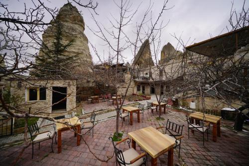 a group of tables and chairs in a courtyard at Glory Art Stone House in Goreme