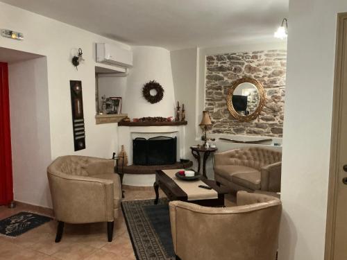 a living room with a couch and a fireplace at Αρχοντικό Πρεπάλα in Neochori