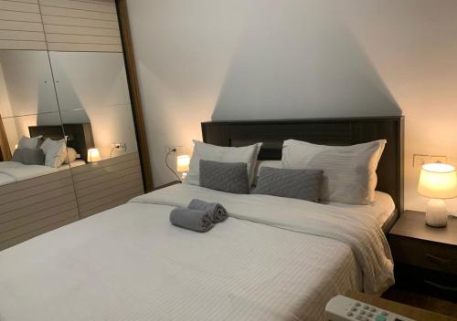 a bedroom with a large bed with a towel on it at Les Lavandins-Yaoundé in Yaoundé