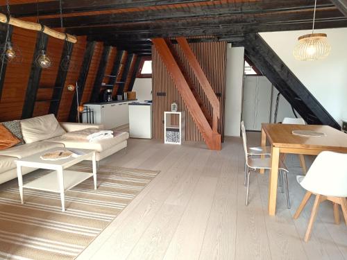 a living room with a couch and a table at Ferienhaus Freilingen 131 in Blankenheim
