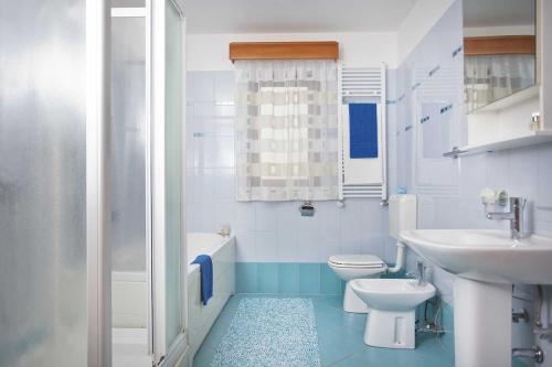 a bathroom with a toilet and a sink at Villa Gloria, a beautifully and modernly furnished villa in Nedeščina