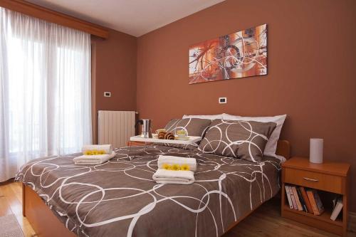 a bedroom with a large bed with two pillows on it at Villa Gloria, a beautifully and modernly furnished villa in Nedeščina