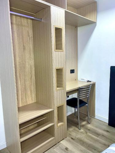 a closet with a desk and a chair in a room at DingãBell ApartHotel in Ikeja