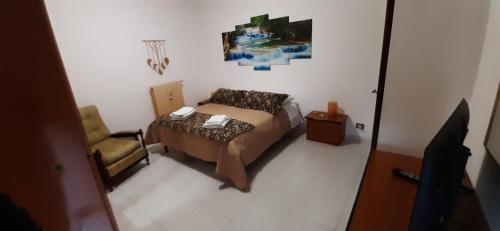 a small bedroom with a bed and a chair at Al Rifugio Nel Borgo in Vitorchiano