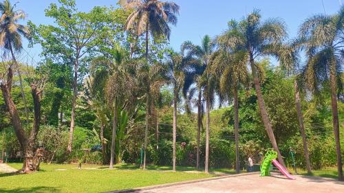 a person standing in a park with a pink object at Golden Landmark Green Valley Beach Resort in Dona Paula