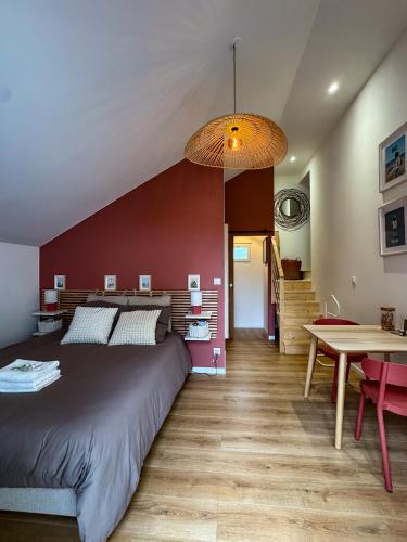 une chambre avec un grand lit et une table dans l'établissement Studio Indépendant, à Ouistreham