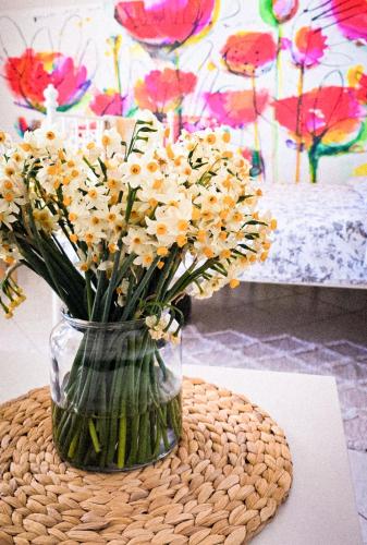 a vase filled with flowers sitting on a table at L'infini Sea View apartments Zubovići in Zubovići