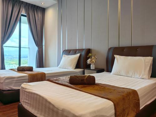 a hotel room with two beds and a window at Near Airport K Avenue Homestay by MINO Suites in Donggongon