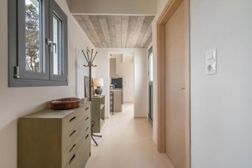 a hallway leading to a kitchen with a window at Cuckoos House in Aegina Town
